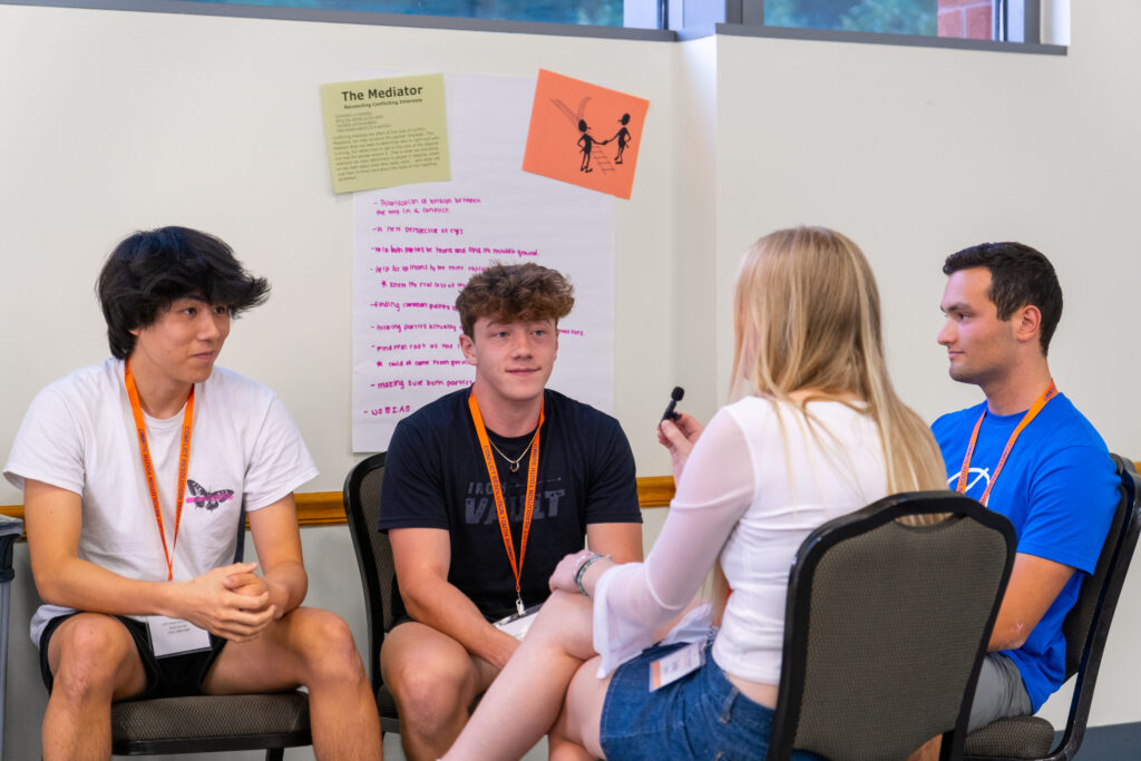 Students discussing the role of a mediator.